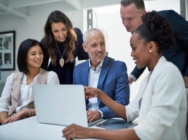 Corporate, discussion and laptop for collaboration, office and employees in meeting, together and CEO. Happy, pitching and idea for brainstorming to boss, public relations and editor for company.
